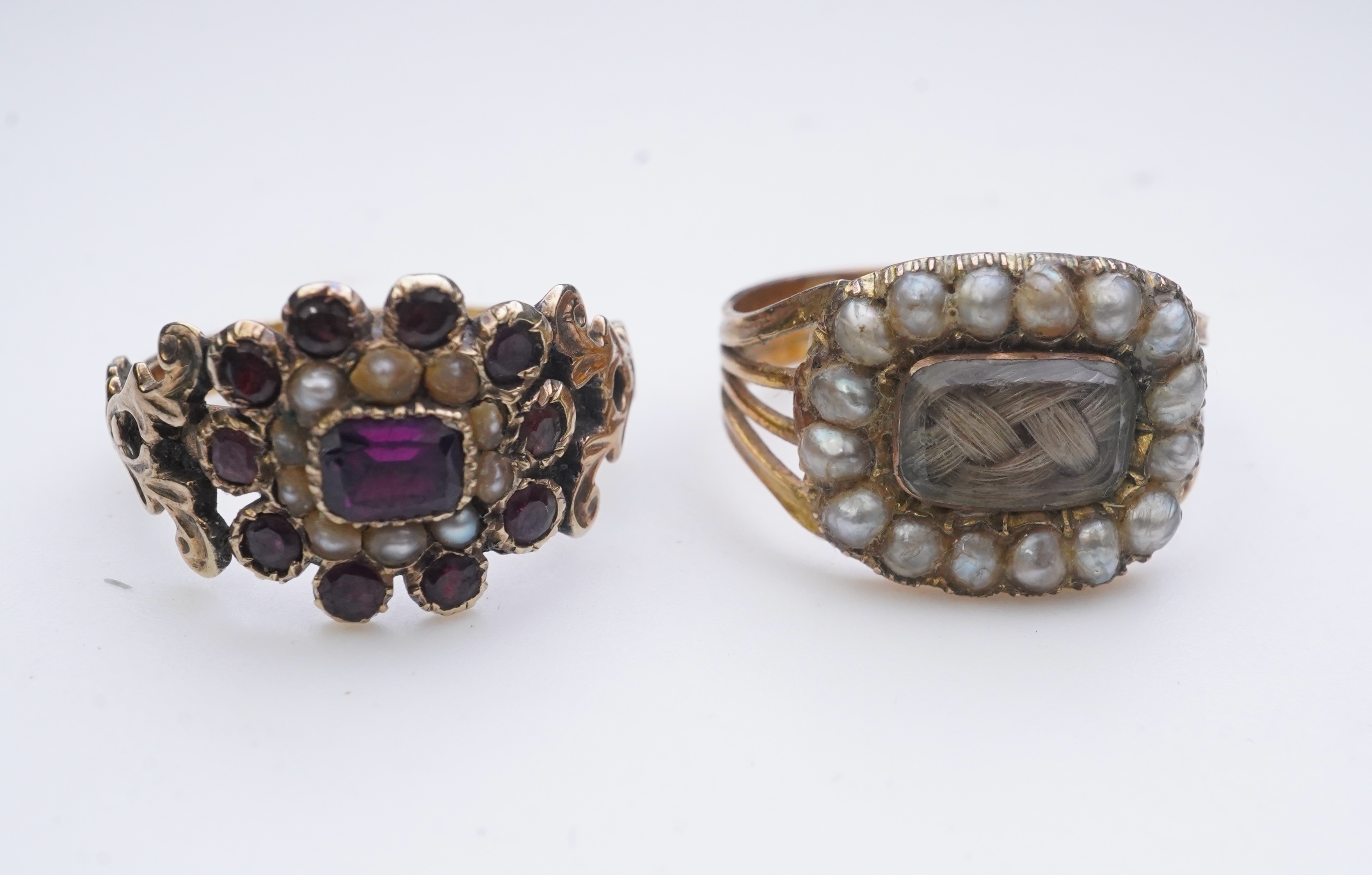 A George III seed pearl mourning ring and a garnet and seed pearl ring, mid 19th century